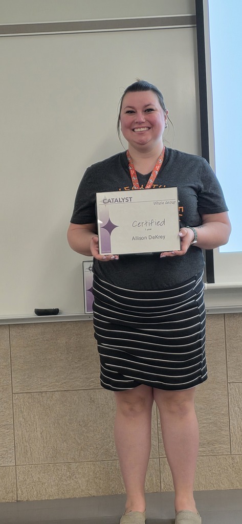 Allison Dekrey holding her Catalyst certificate