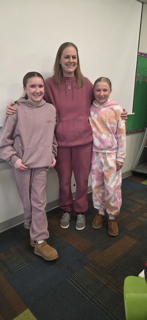 Students posing with their teacher for pajama day