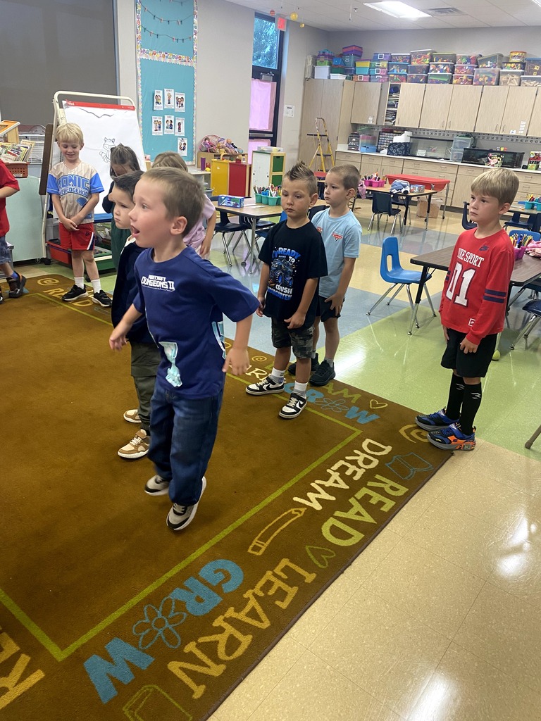 Kindergarten students dancing in a classroom