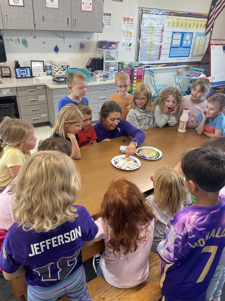 Ms Hambly and her students are excited seeing the effects of the magic milk experiment.