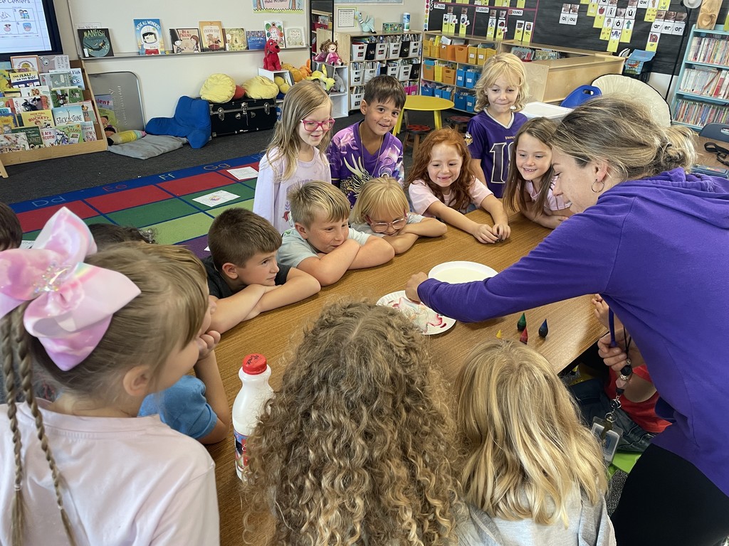 More students showing interest and excitement in the magic milk experiment.