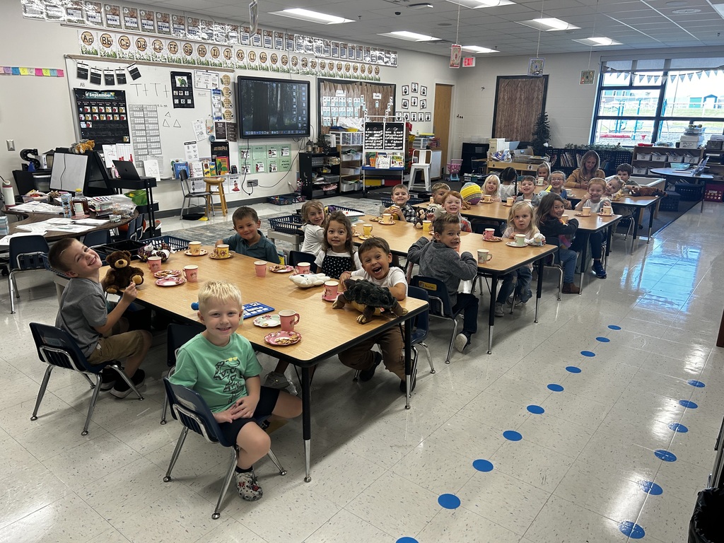 All students smiling and enjoying the tea party.
