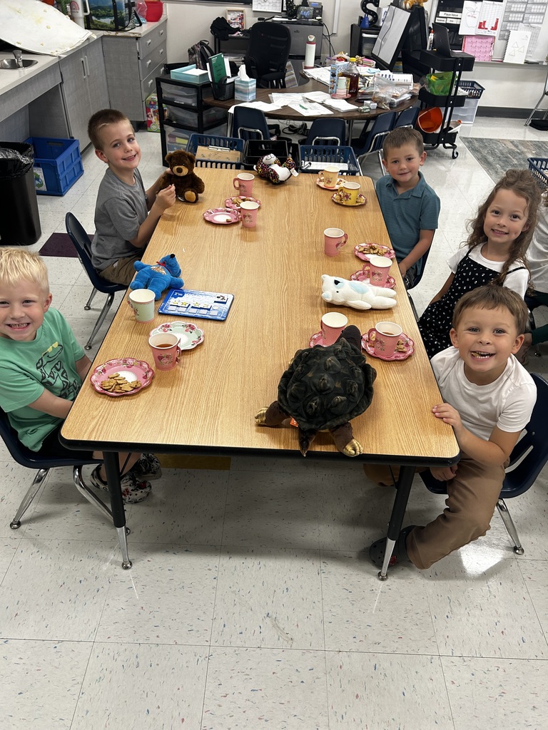 5 student enjoying the tea party with their teddy bears at their table.