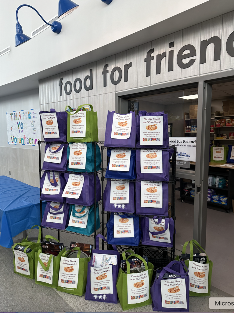 Food For Friends bag organized on a rack at Mora High School