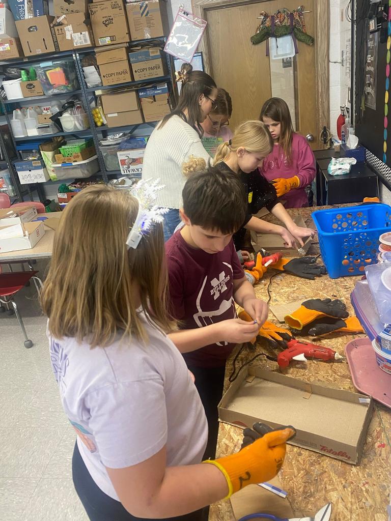 group of students working on cardboard wagon