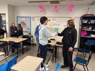 two students shaking hands