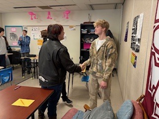 two students shaking hands