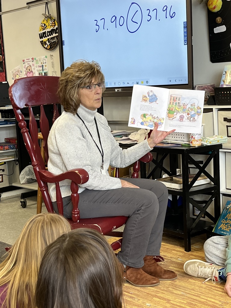 adult reading a book to the class