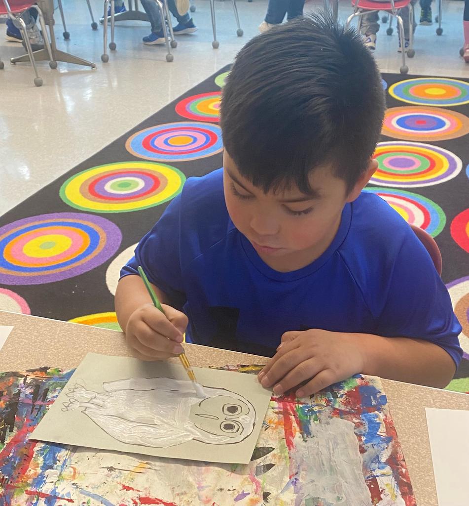 students holding their painted owl project