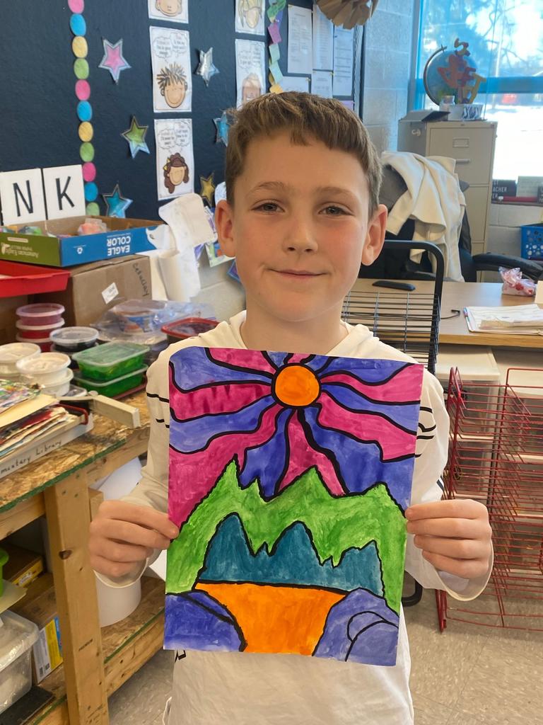 student holding abstract art project
