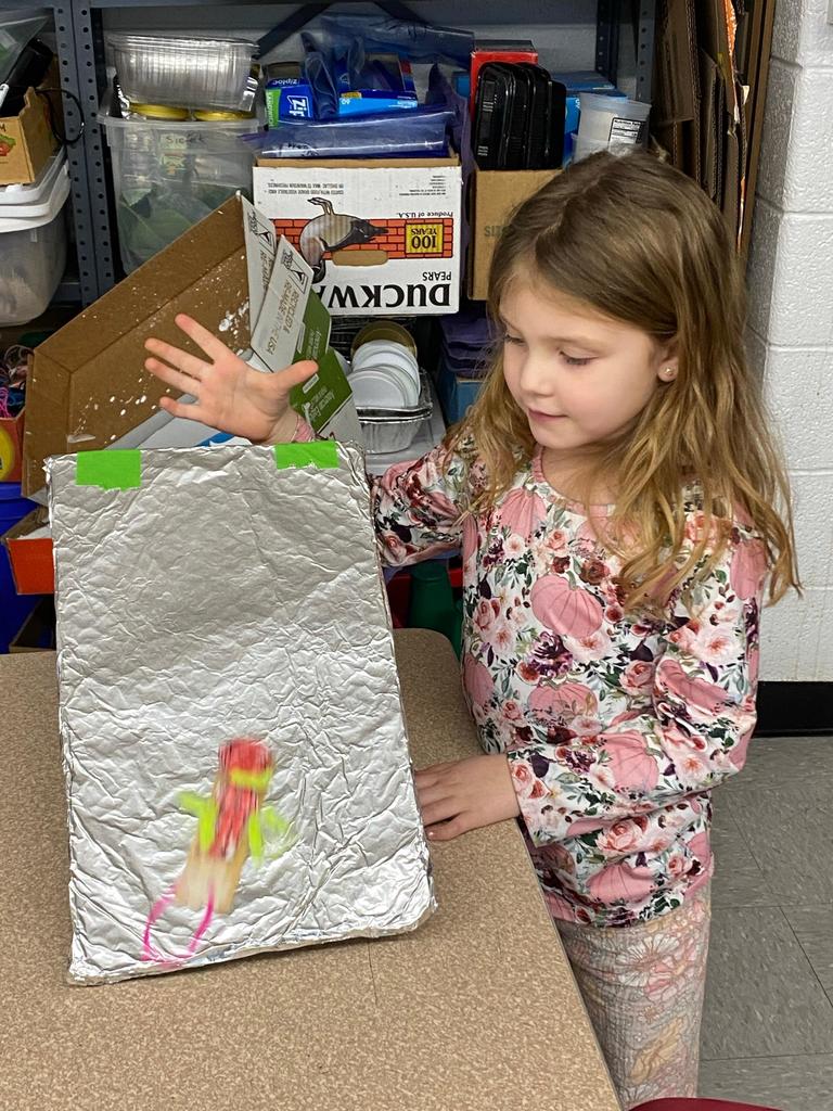 students testing out the sleds they engineered during steam class.