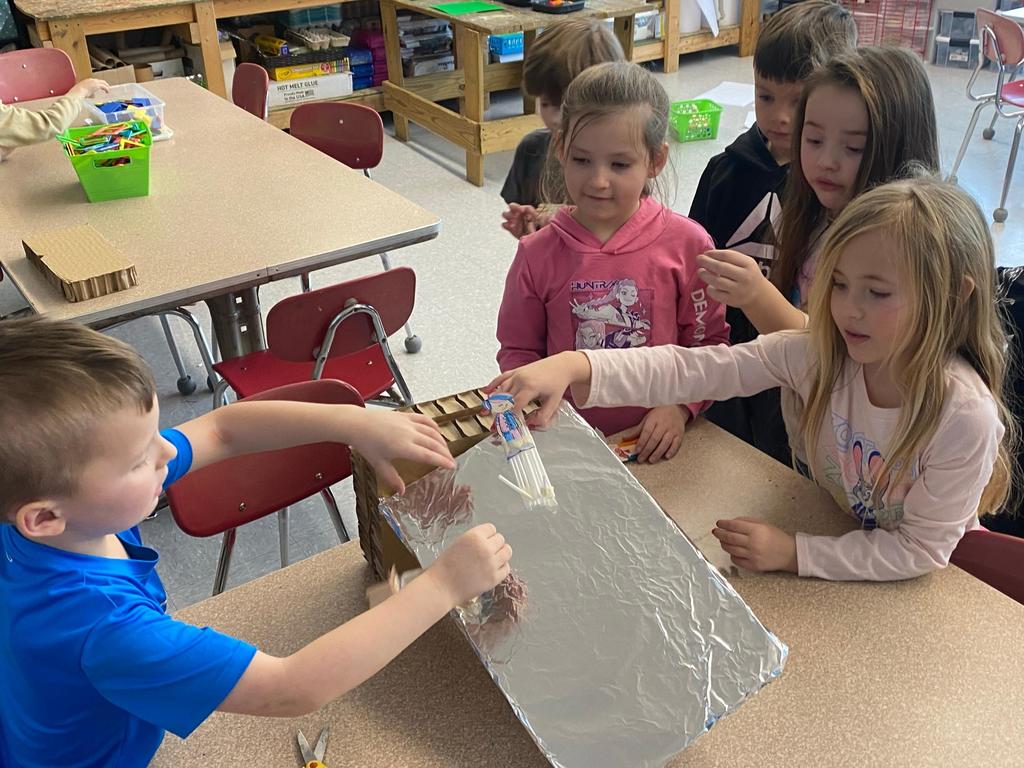 students testing out the sleds they engineered during steam class.