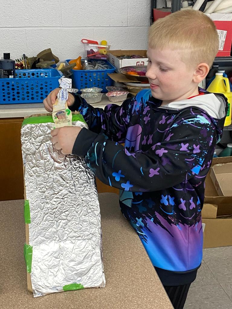 students testing out the sleds they engineered during steam class.