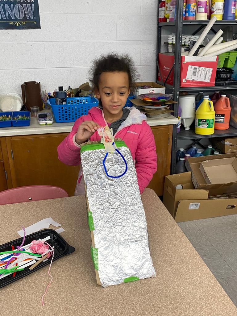 students testing out the sleds they engineered during steam class.