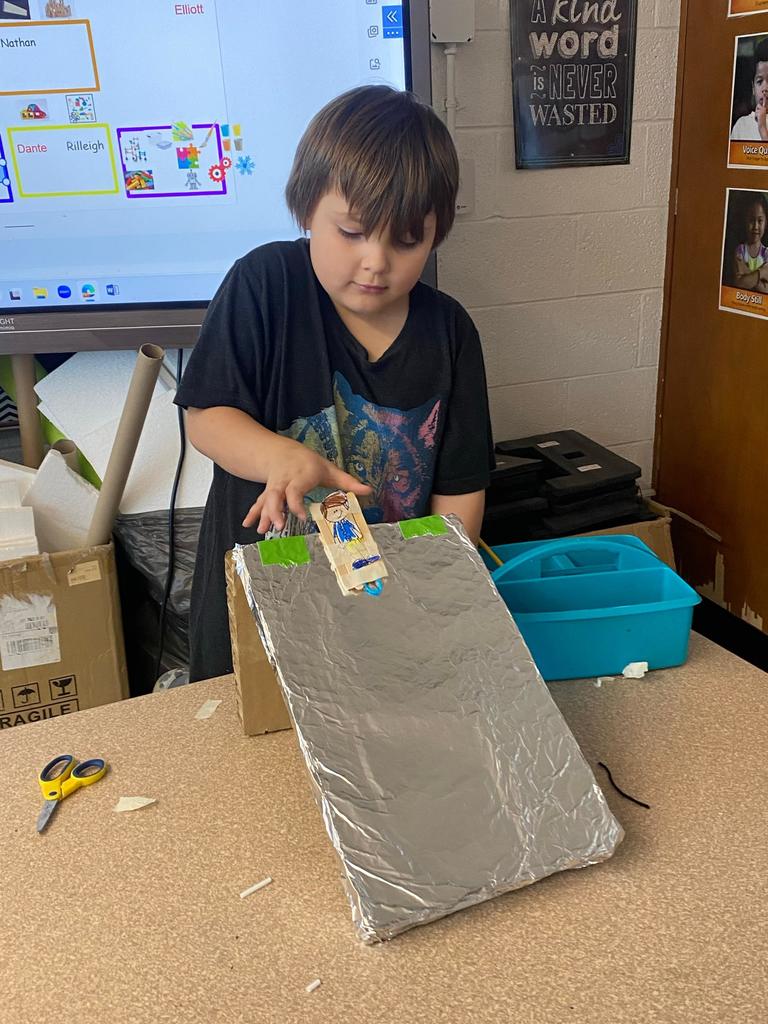 students testing out the sleds they engineered during steam class.