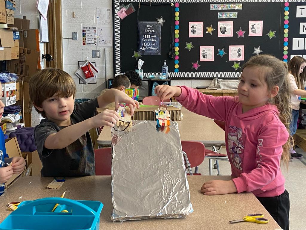 students testing out the sleds they engineered during steam class.