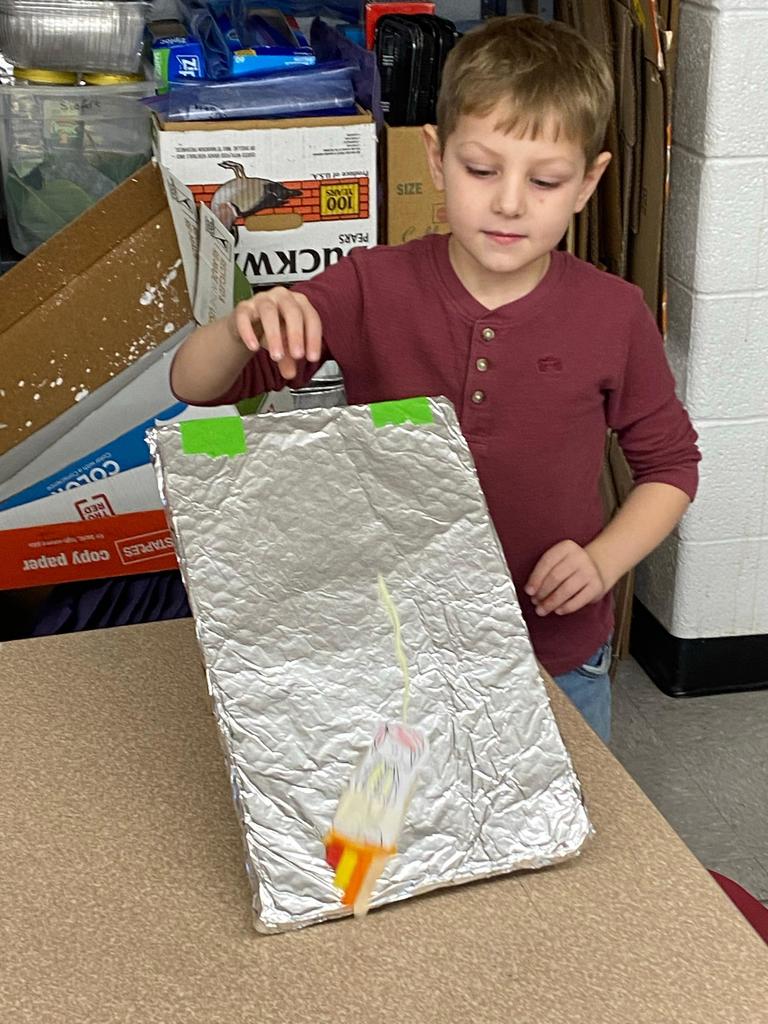students testing out the sleds they engineered during steam class.