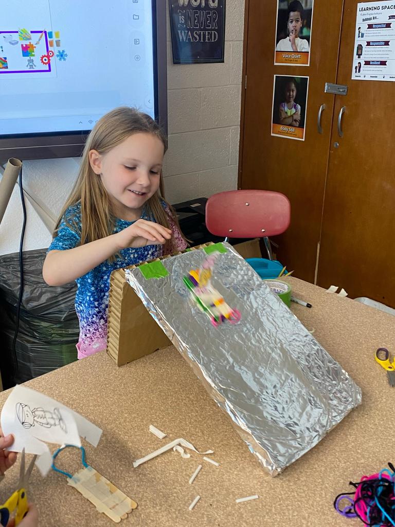 students testing out the sleds they engineered during steam class.