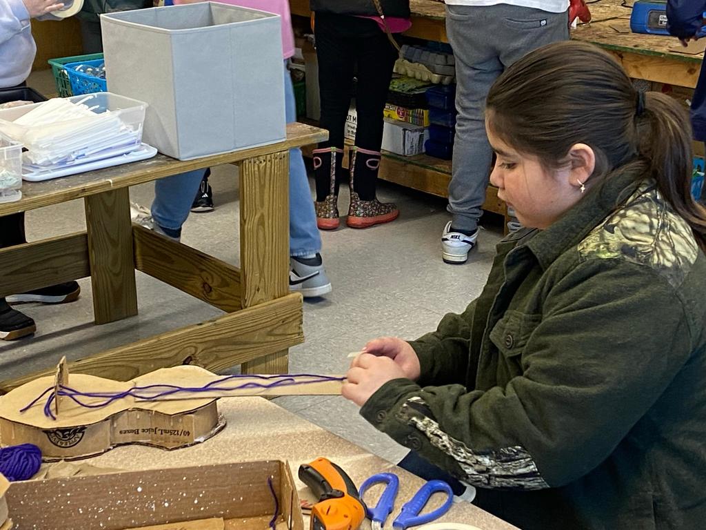 students making violins out of cardboard