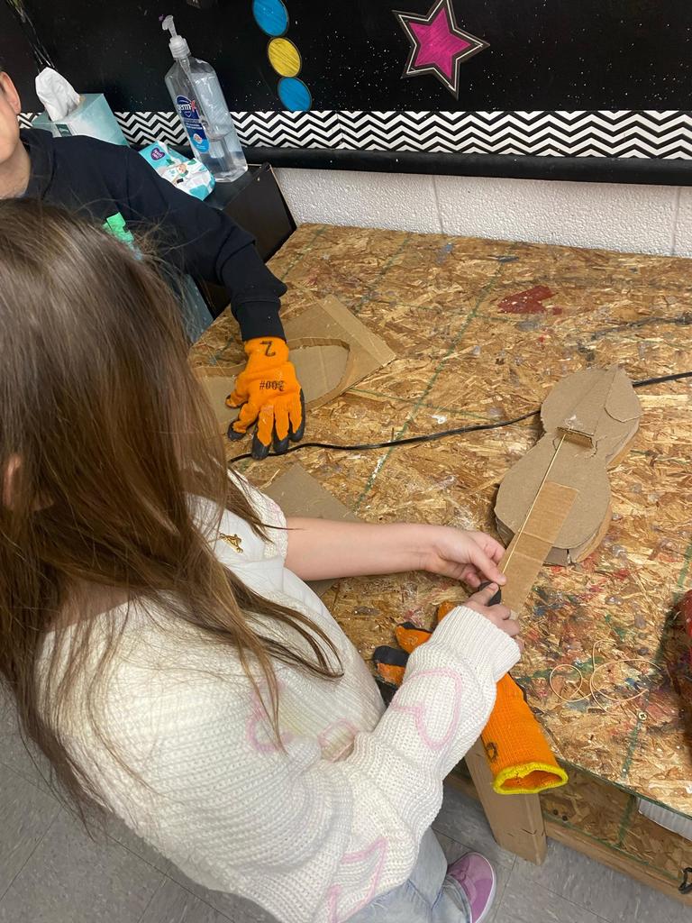 students making violins out of cardboard