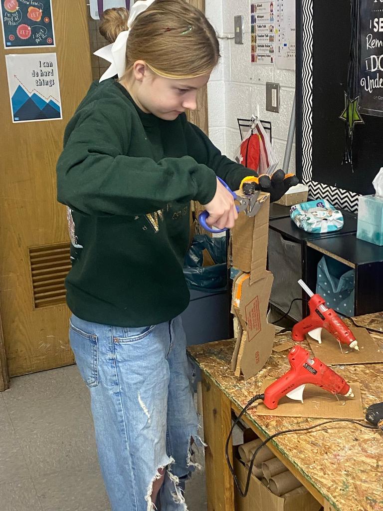 students making violins out of cardboard