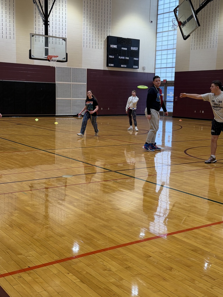 students playing indoor frisbee