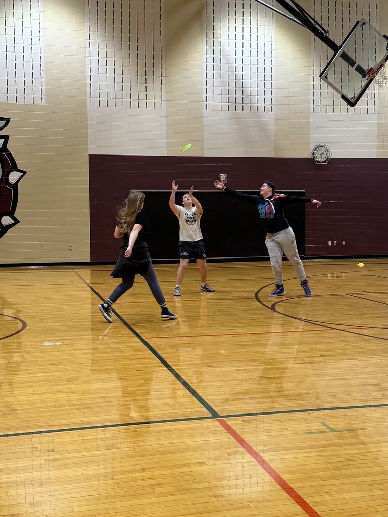 students playing indoor frisbee