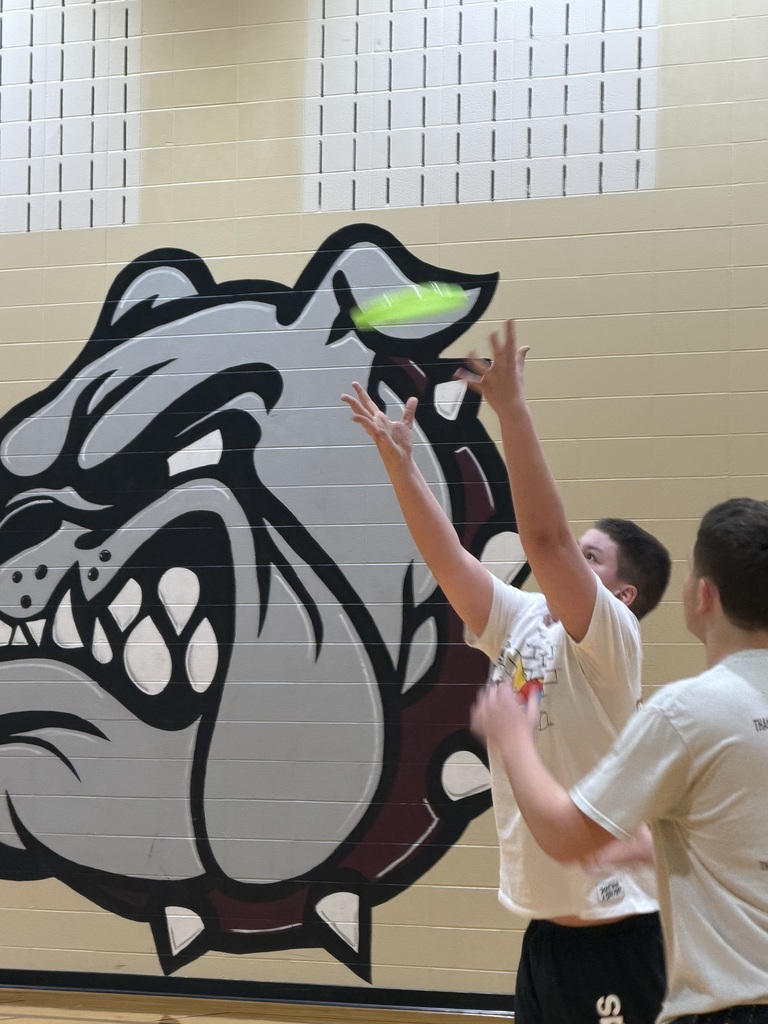 students playing indoor frisbee