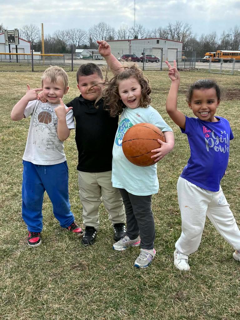 four students having fun on the playground