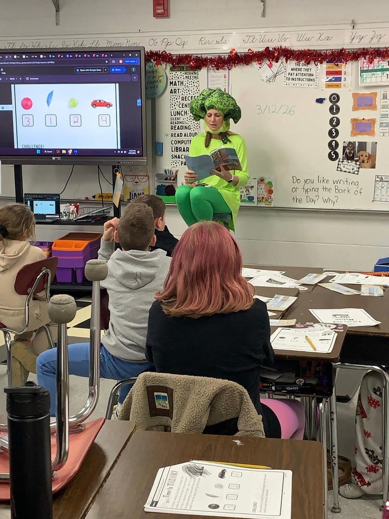 teacher reading dressed up as broccoli