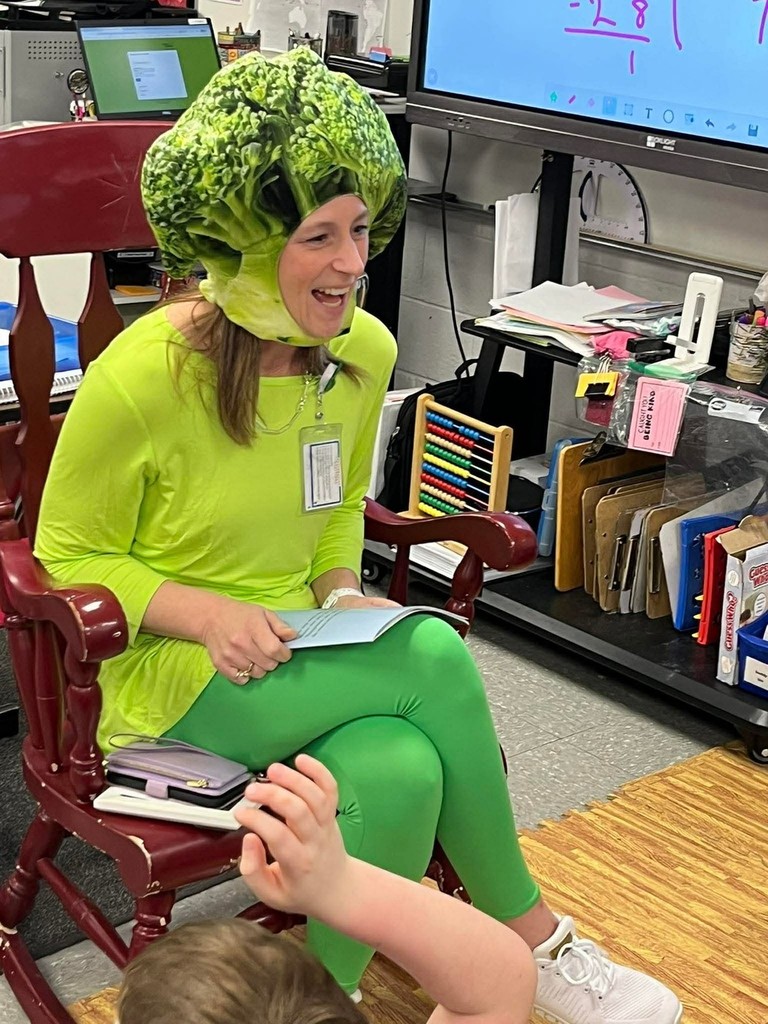 teacher reading dressed up as broccoli