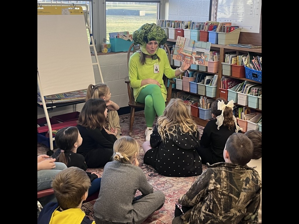 teacher reading dressed up as broccoli
