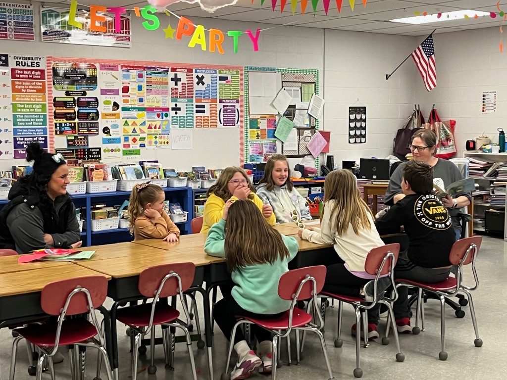 group of students listening to a book read