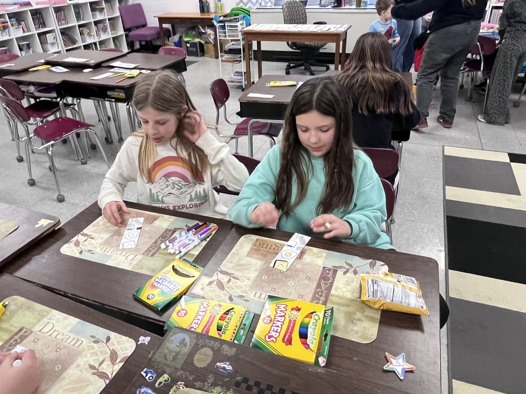 two girls coloring a bookmark