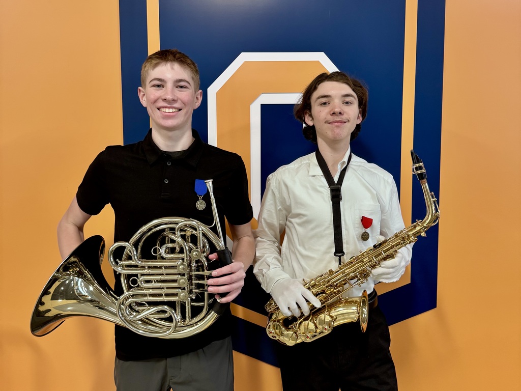 two students holding their instruments