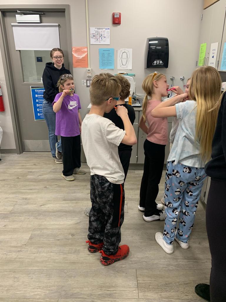 students brushing their teeth