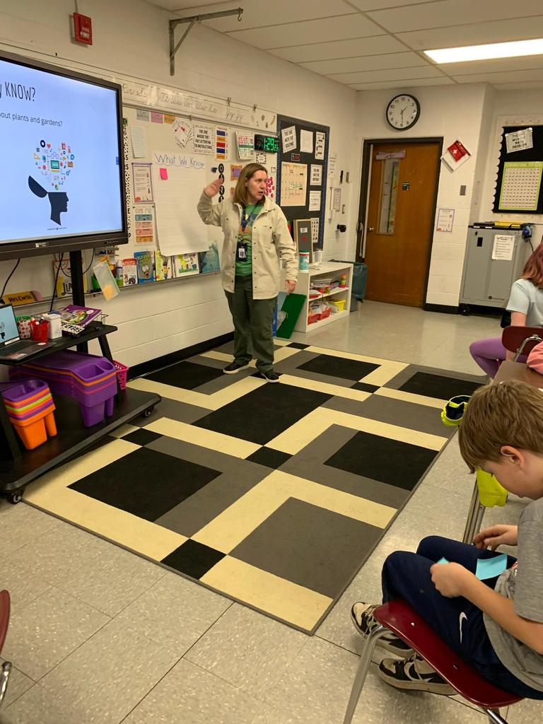 student in front of class teaching