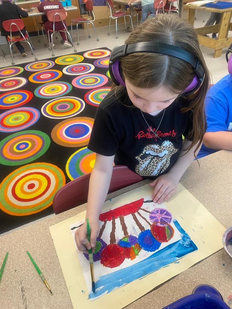 student painting a lollipop picture