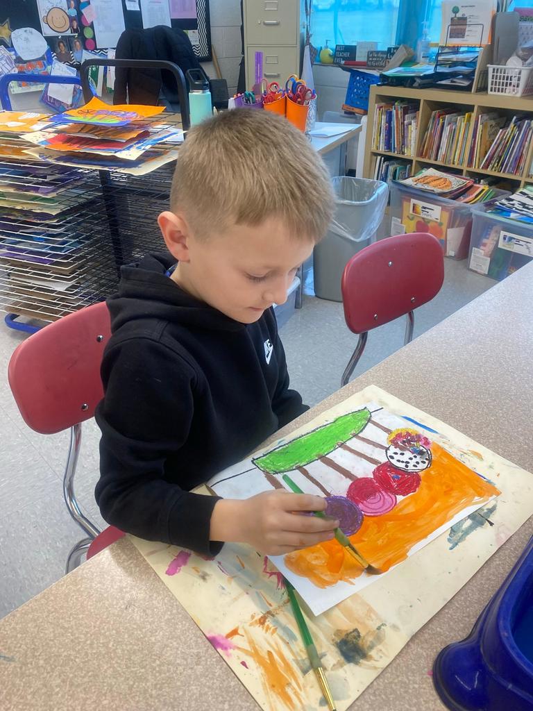 student painting a lollipop picture