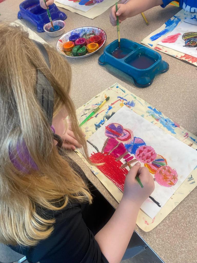 student painting a lollipop picture