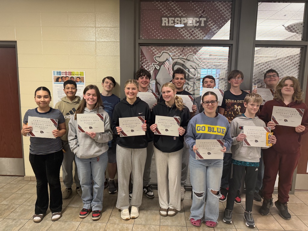 students holding certificate for perfect attendance.