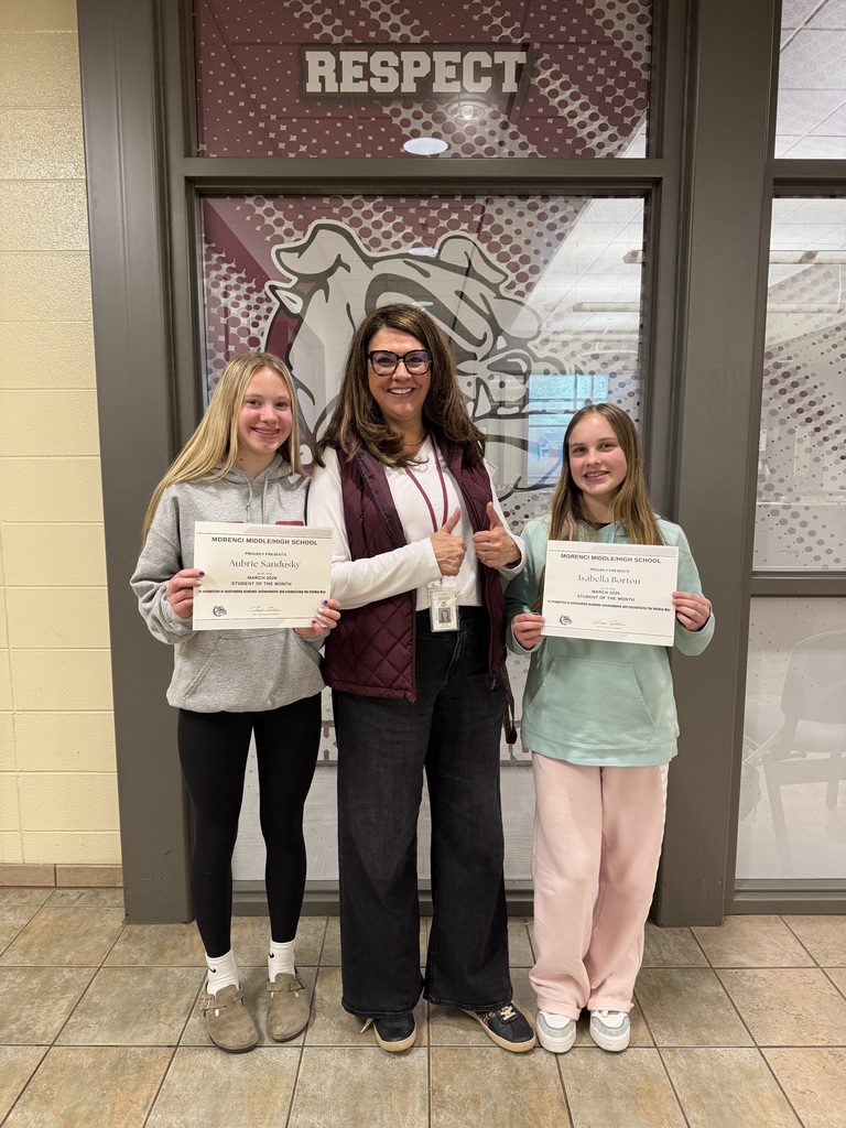 March students of the month holding certificates with Superintendent Ellis.