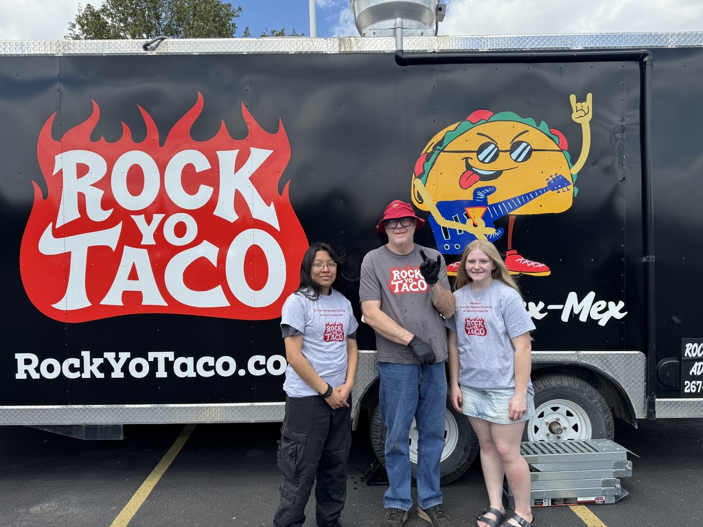 Three people pictured in front of the Rock Yo Taco food truck