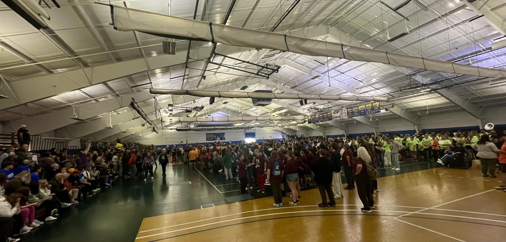 a room full of students and adults at the special olympics.