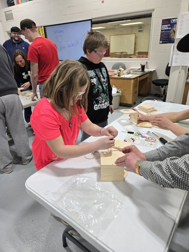 student building a birdhouse