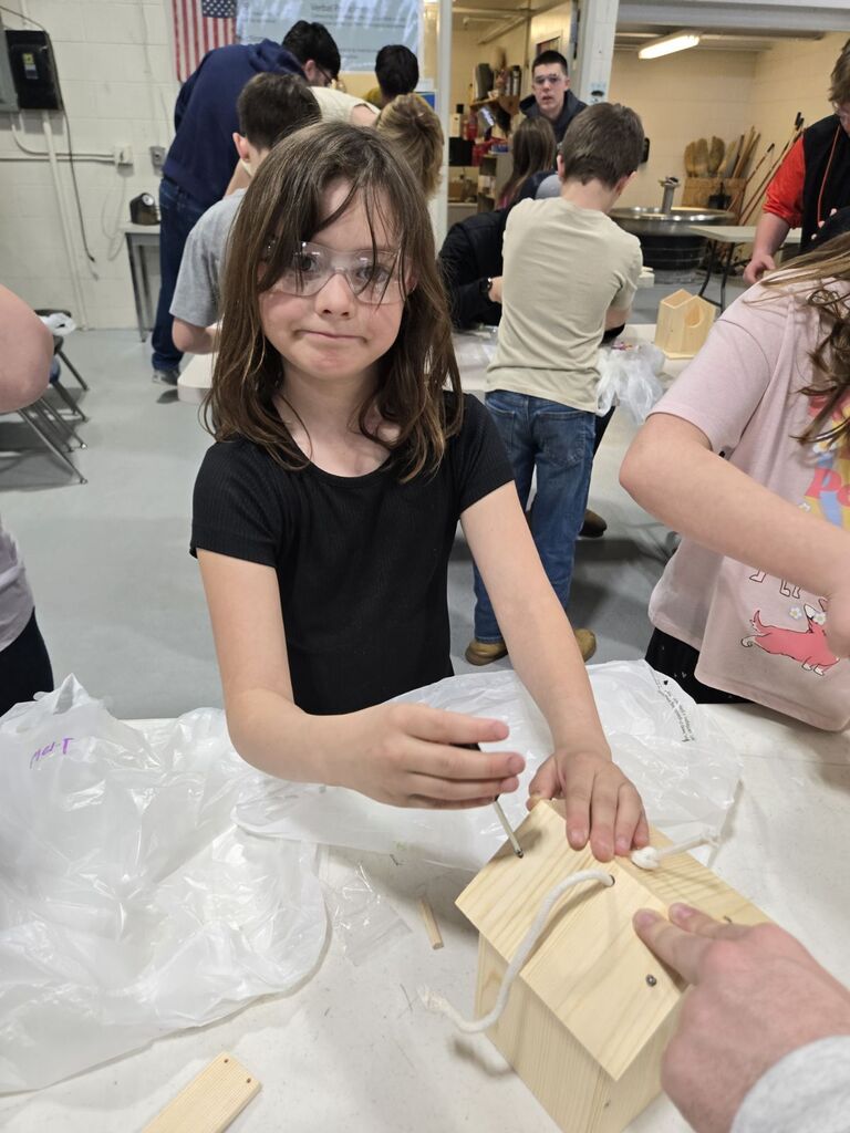 student building a birdhouse