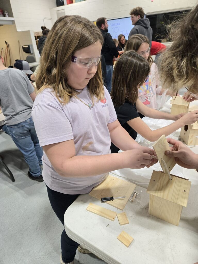 student building a birdhouse