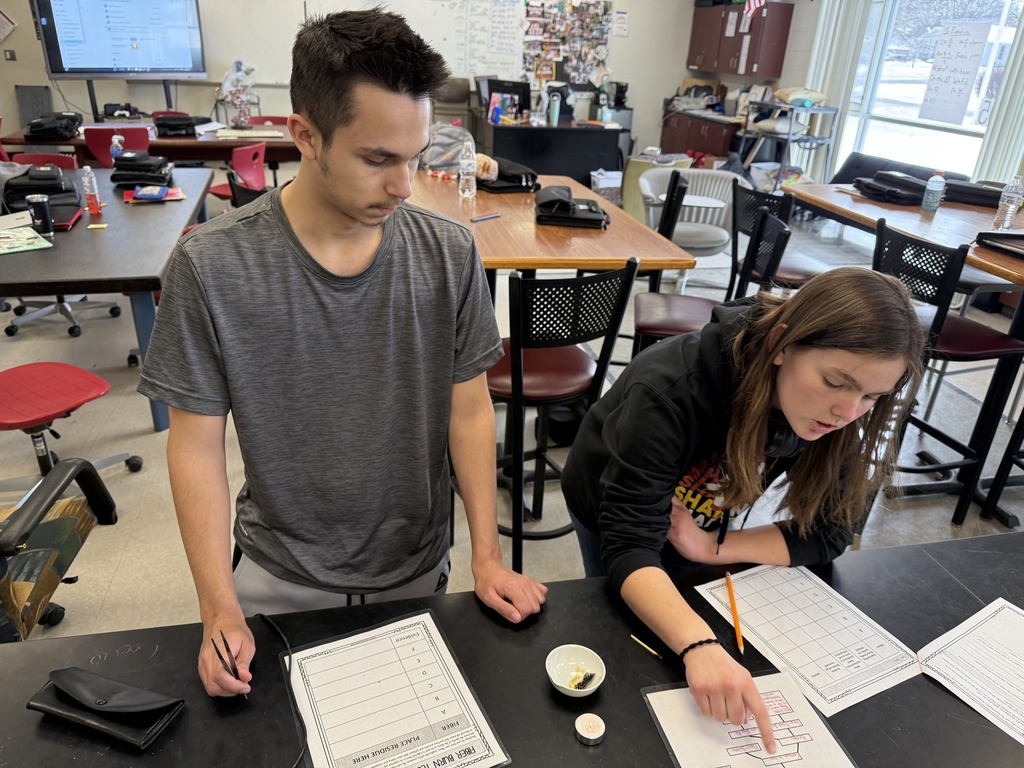 students working on a worksheet in science lab