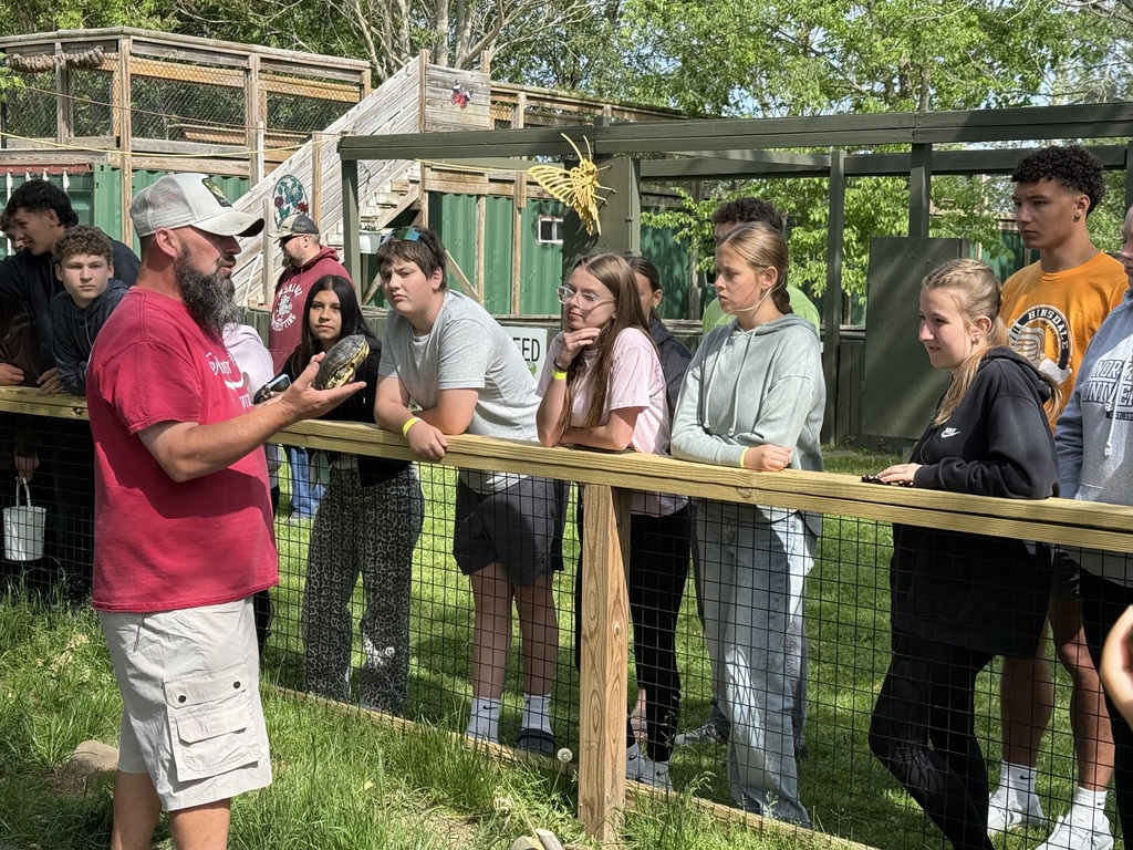 students listing to speaker talk about an aligator