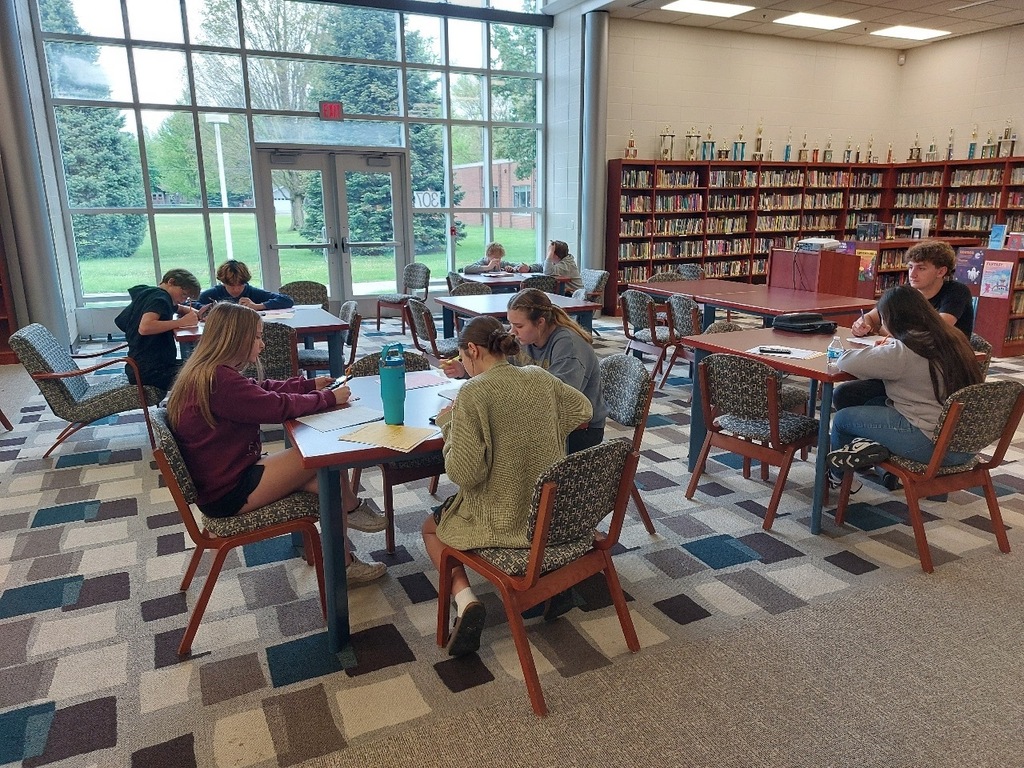 students working in groups in the media center